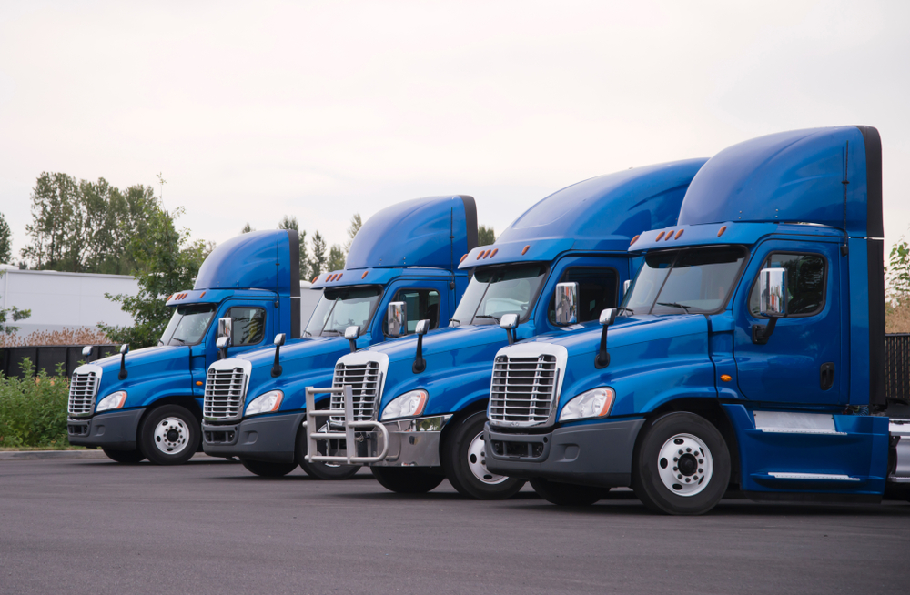 fleet of blue trucks on the road