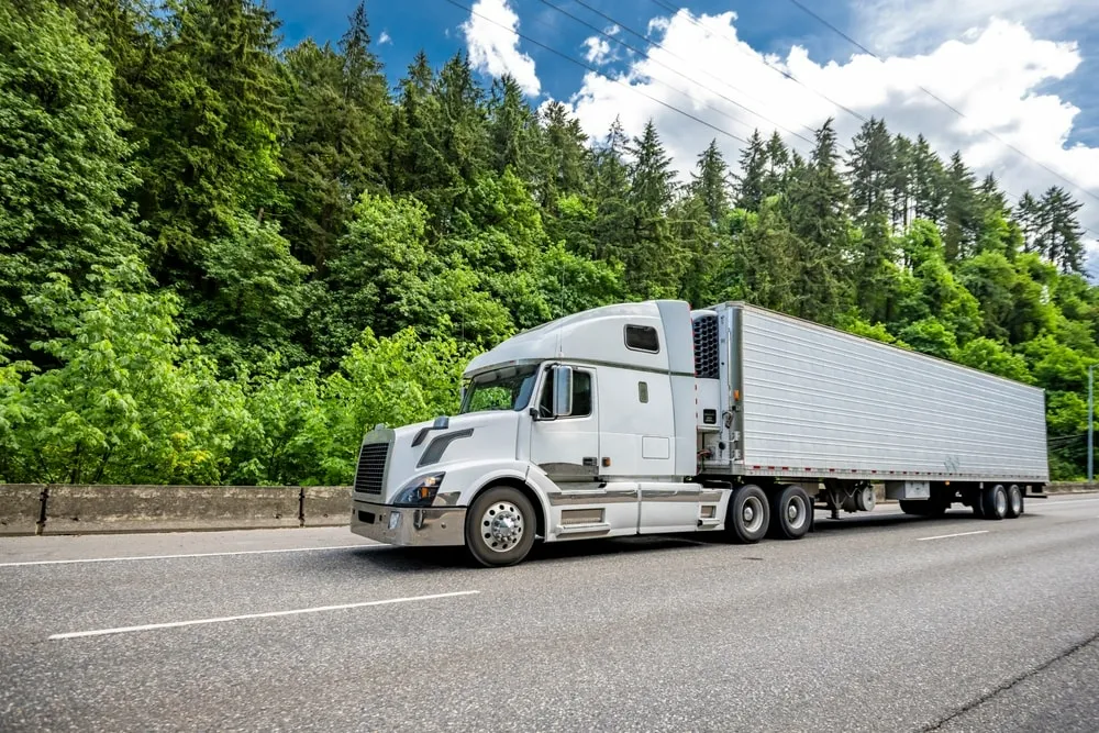 A truck driver practicing defensive driving techniques on the road.