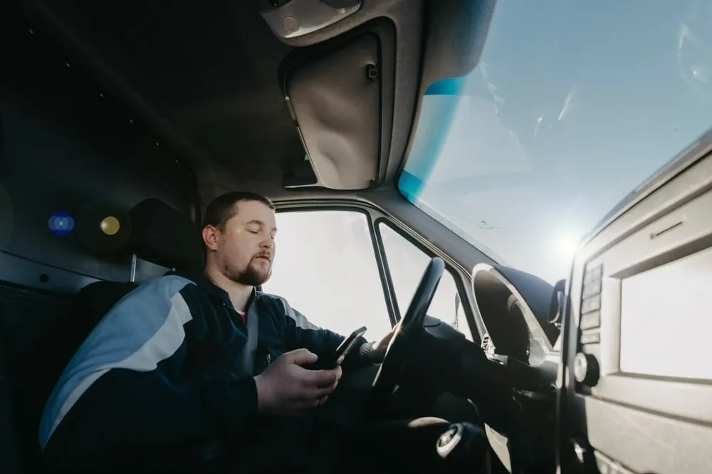 A truck driver avoiding distractions while driving.